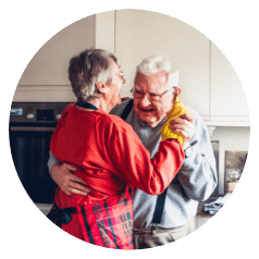 Older couple dances in the kitchen