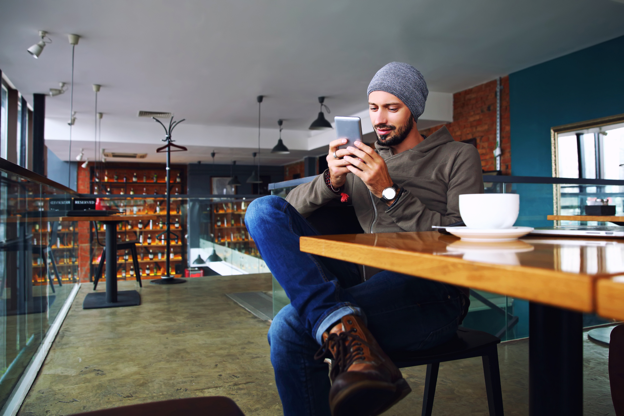 Man sitting at table looking at tablet device