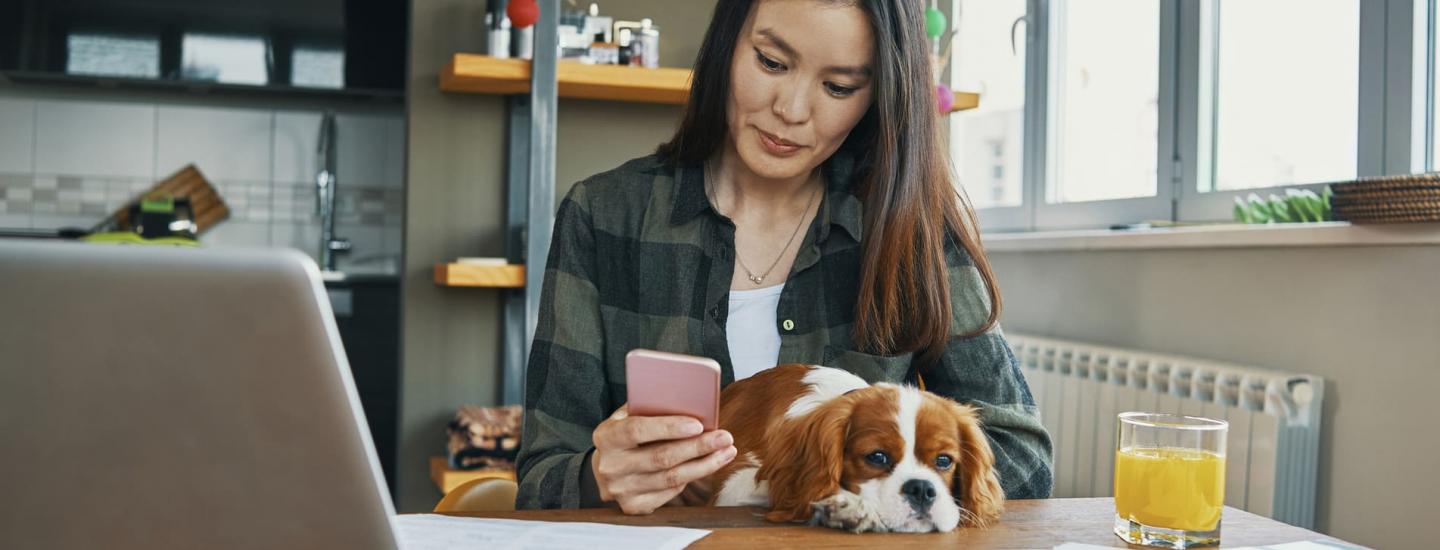 Woman using a mobile phone to deposit a paper check
