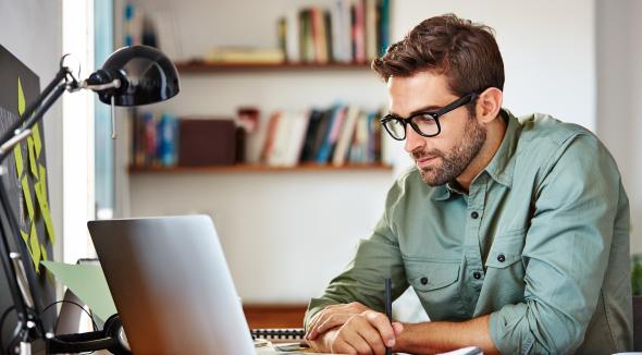 man using laptop at desk