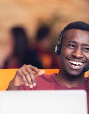 man on call in contact center smiling