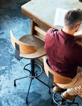Man at table sing laptop