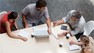 Co-workers work together at table