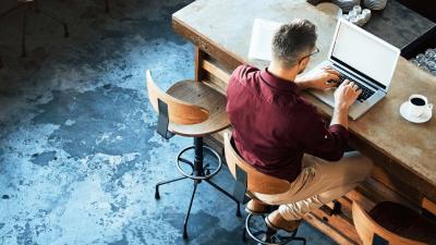 Man works on laptop at desk