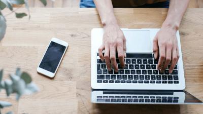 birds eye view of person using laptop at desk